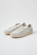 Sneakers blancas con detalles glider dorado