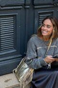 Bolso de piel con flecos dorado metalizado